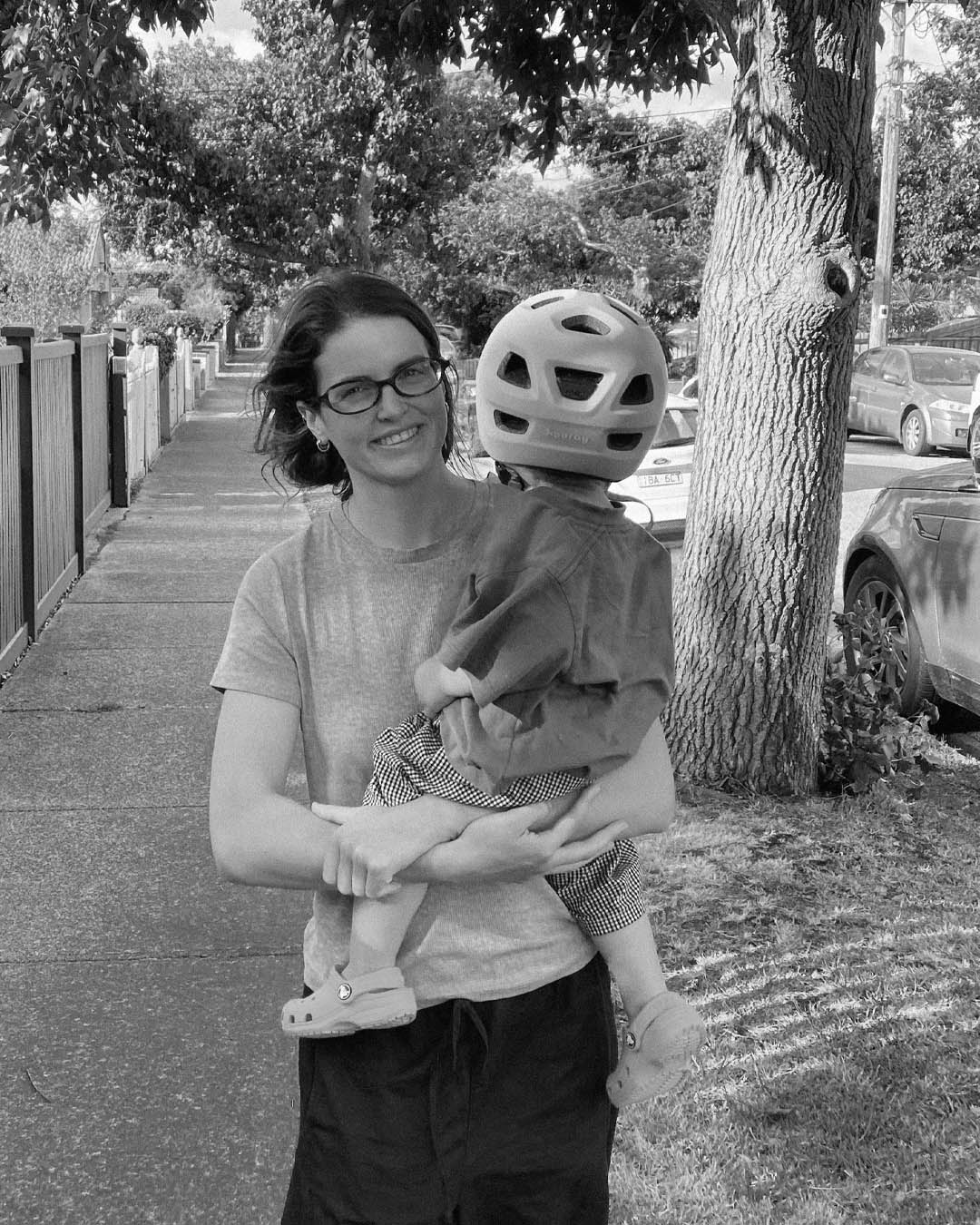 Mother and son pictured together. Son is looking away while the mother smiles at the camera